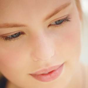 Close-up of a beautiful young woman looking down
