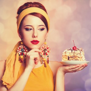 Style redhead girl with cake.