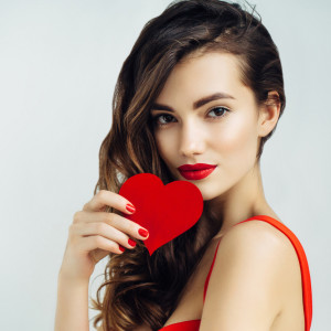 Beautiful girl holding artificial heart