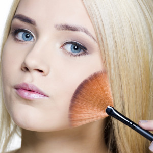 Young Woman applying makeup