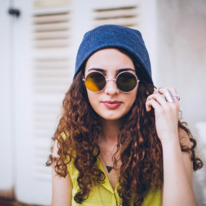 Hip hop style female with sunglasses and winter cap