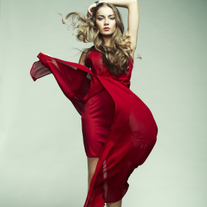 Fashion photo of young magnificent woman in red dress