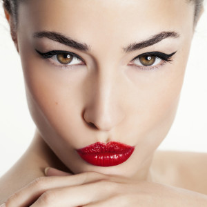 closeup woman portrait with red lips and black eyeliner
