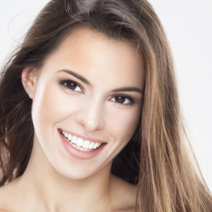 Beauty portrait of a young brunette woman with beautiful smile