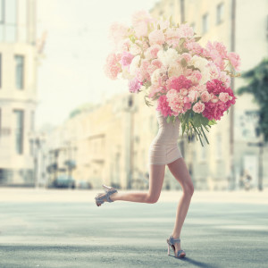 running women with giant bunch of flowers