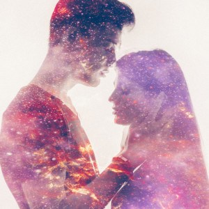 Silhouette of a loving couple with galaxy in their forms