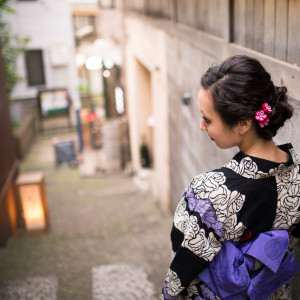 Young Yukata woman walking down narrow slope
