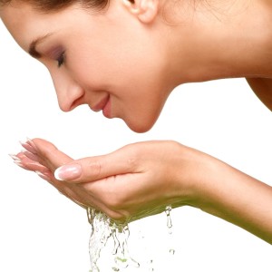 beautiful-woman-refreshing-her-face-with-water-picture-id467257239