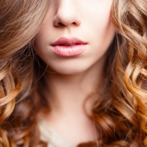 beautiful-pink-lips-closeup-girl-with-curly-hair-picture-id547523910
