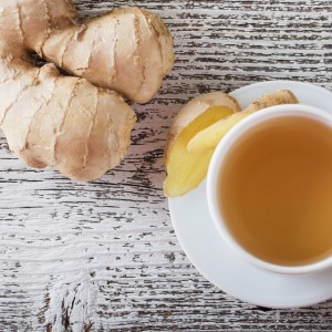 ginger-tea-in-a-white-cup-on-wooden-background-picture-id492223016
